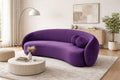 Purple sofa in a modern living room with a coffee table and decor items.