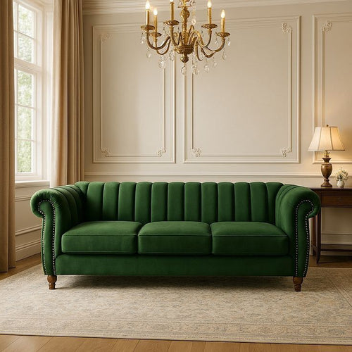 Green sofa in a stylish living room with a chandelier and lamp.