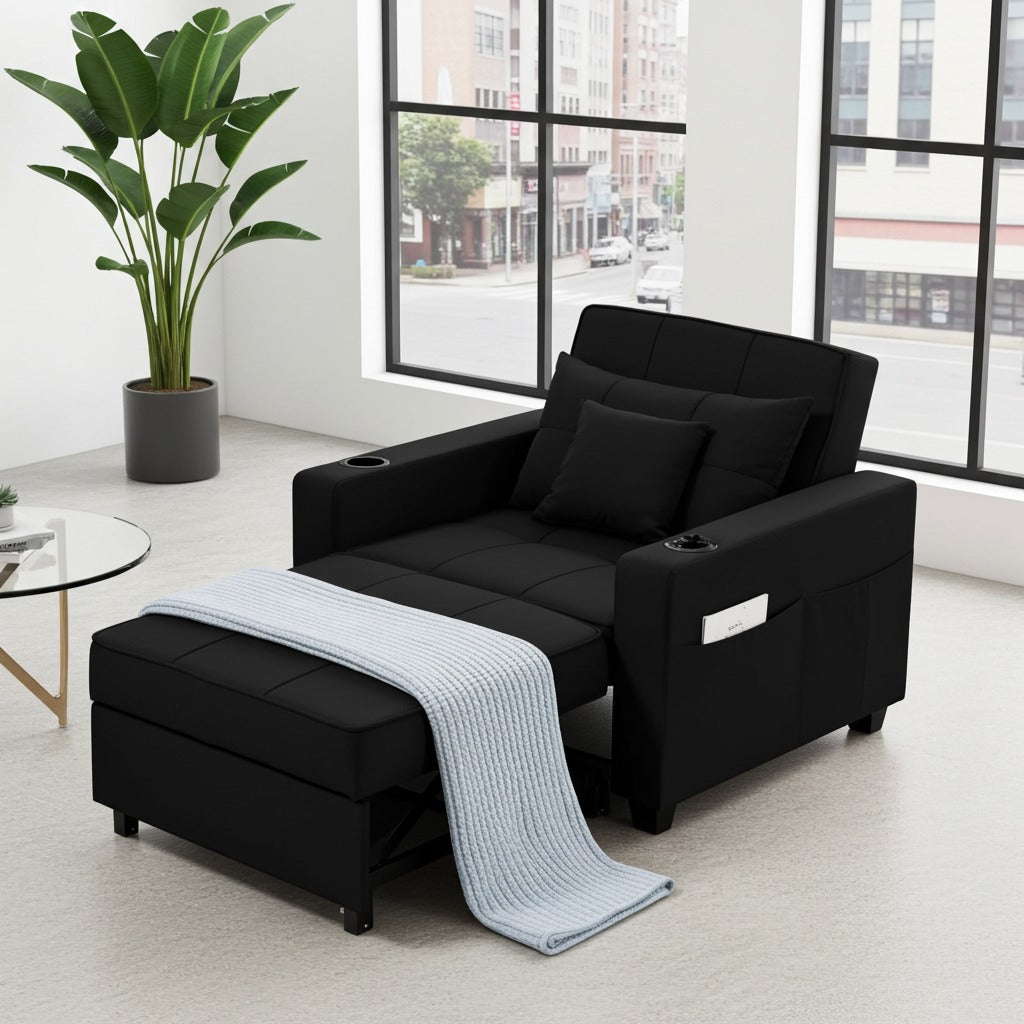 A black reclining sofa bed with an ottoman base, shown in a bright modern room with large windows, a potted plant, and a light blue throw blanket draped over the front.