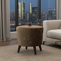 A round upholstered ottoman with a brown and beige marble-look pattern sits in a modern living room setting with a city skyline visible through large windows in the background.