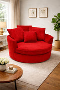 Red circular sofa in a living room with a coffee table and decor items.