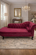 Magenta velvet chaise lounge in a stylish room with a mirror, lamp, and decor.