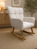 White rocking chair in a room with wooden floor and decor elements.