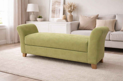 Green sofa in a living room setting with a neutral color palette