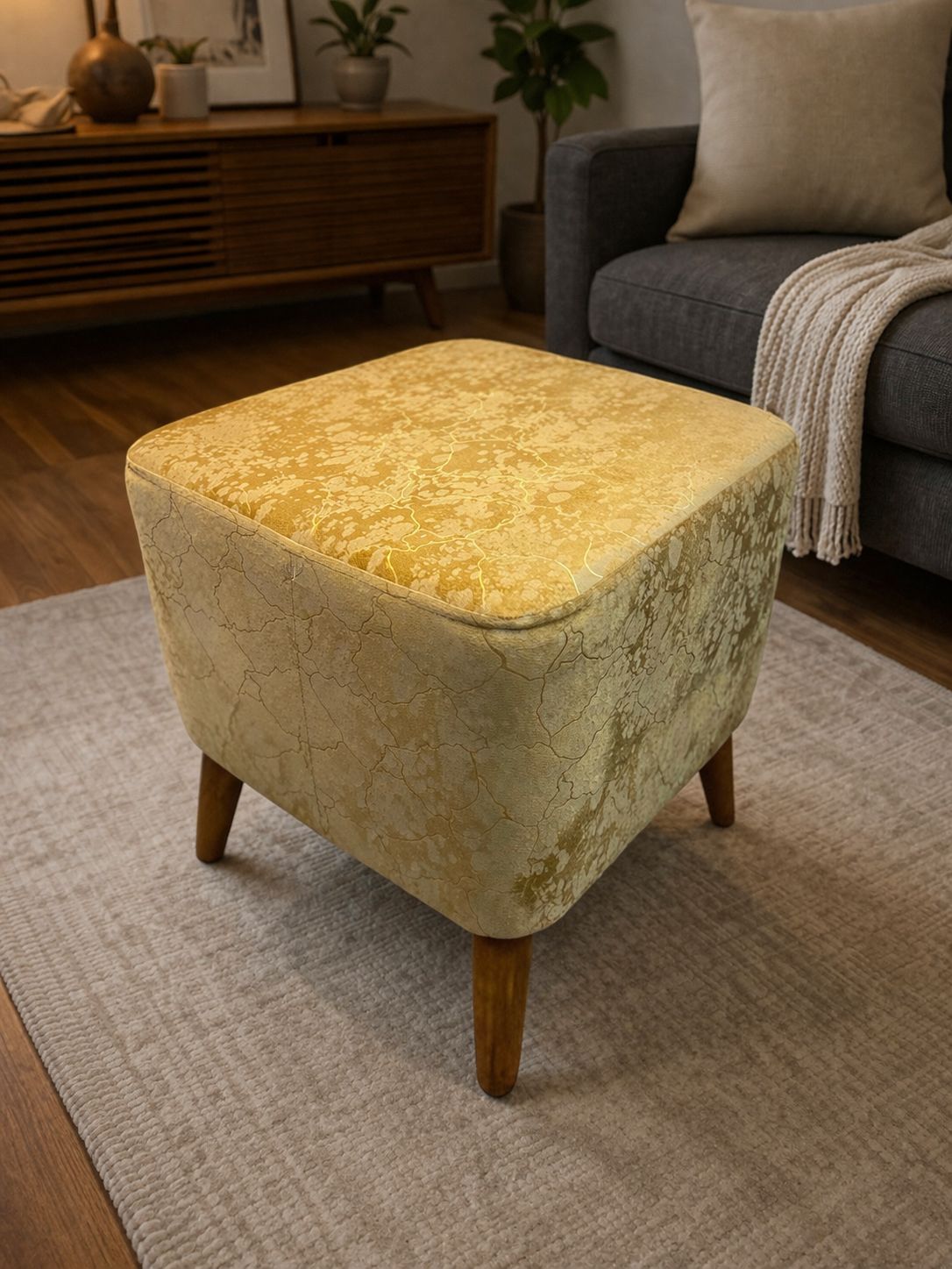 Decorative ottoman with floral pattern in a living room setting